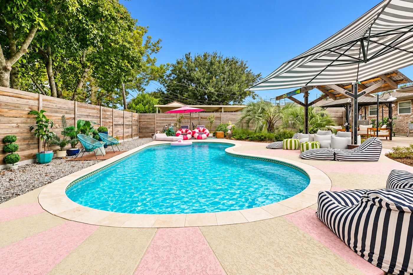Freeform pool with coated deck and lounge area
